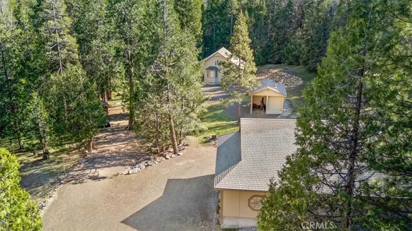 an aerial view of a house with a yard