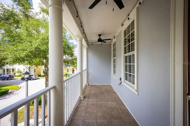 a view of a porch with wooden floor and windows