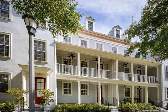 a front view of a building with a tree