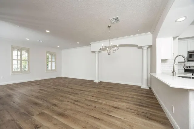 a view of a kitchen with a sink and a wooden floor