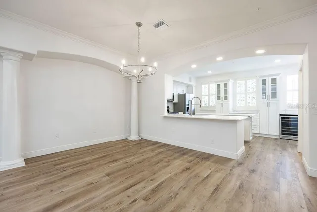 a view of kitchen with granite countertop cabinets and wooden floor