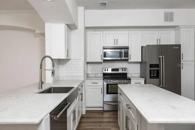 a kitchen with a sink a stove and refrigerator