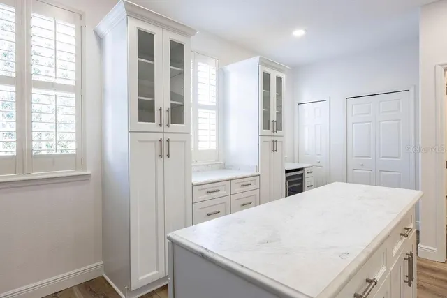a kitchen with a refrigerator a sink and dishwasher with wooden floor