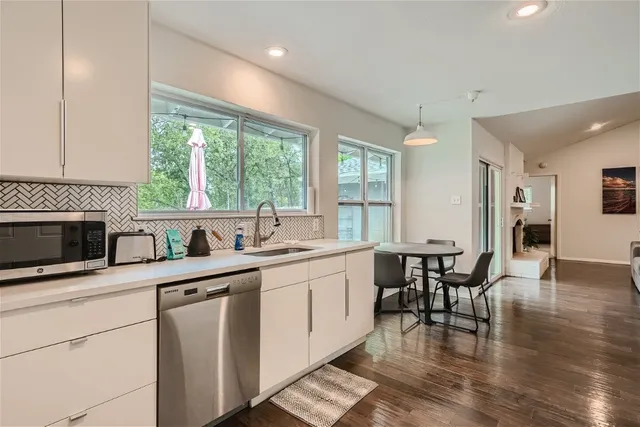 a kitchen with a stove a sink and a microwave