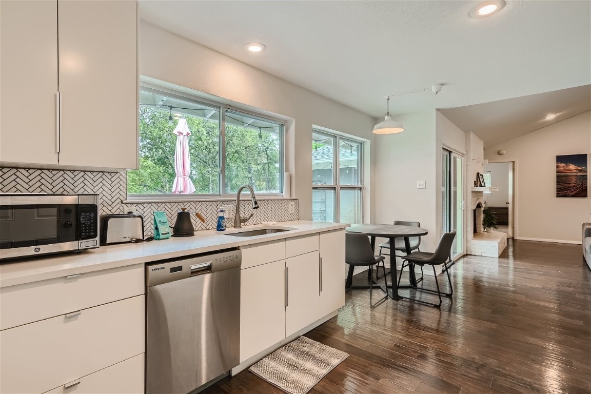 6614 Ashland Drive Austin, TX 78723 - Photo 12 of 28 a kitchen with a stove a sink and a microwave