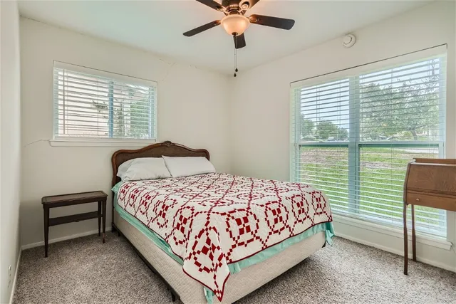 a bedroom with a bed and window