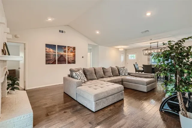 a living room with furniture a window and a potted plant