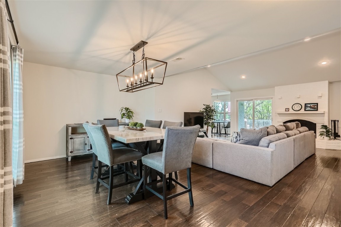 6614 Ashland Drive Austin, TX 78723 - Photo 8 of 28 a living room with furniture a dining table and a chandelier