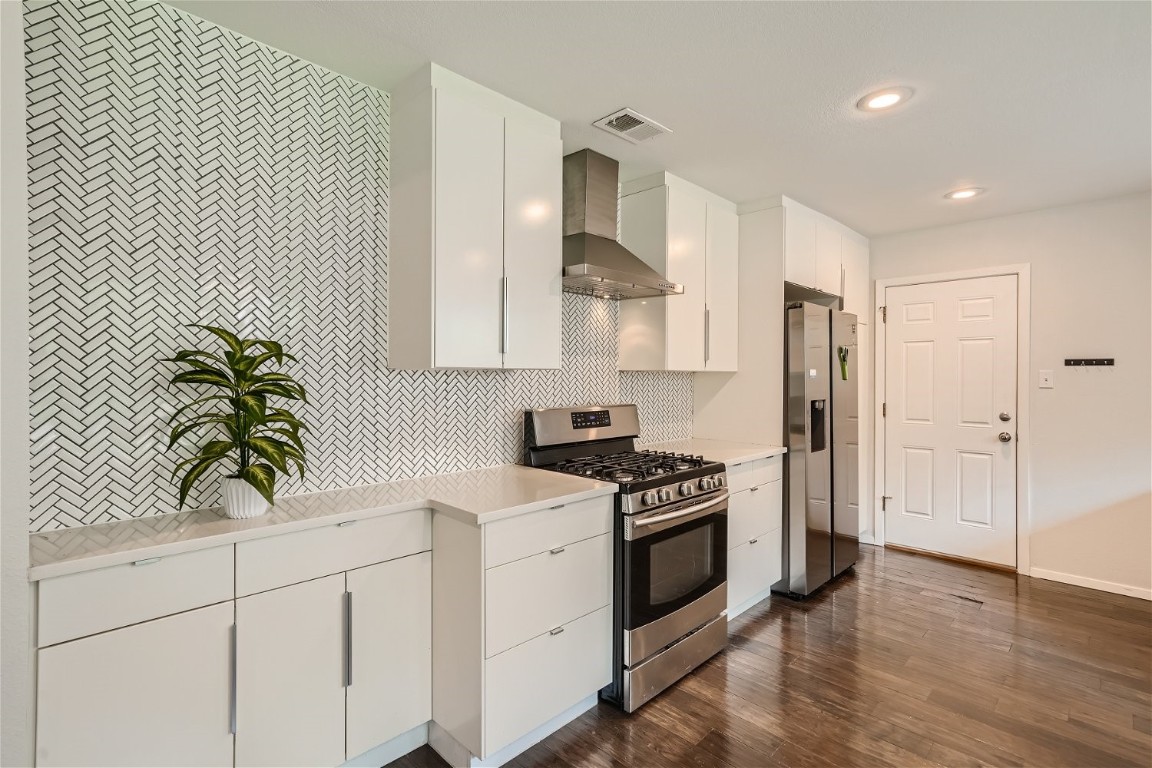 6614 Ashland Drive Austin, TX 78723 - Photo 10 of 28 a kitchen with white cabinets and appliances