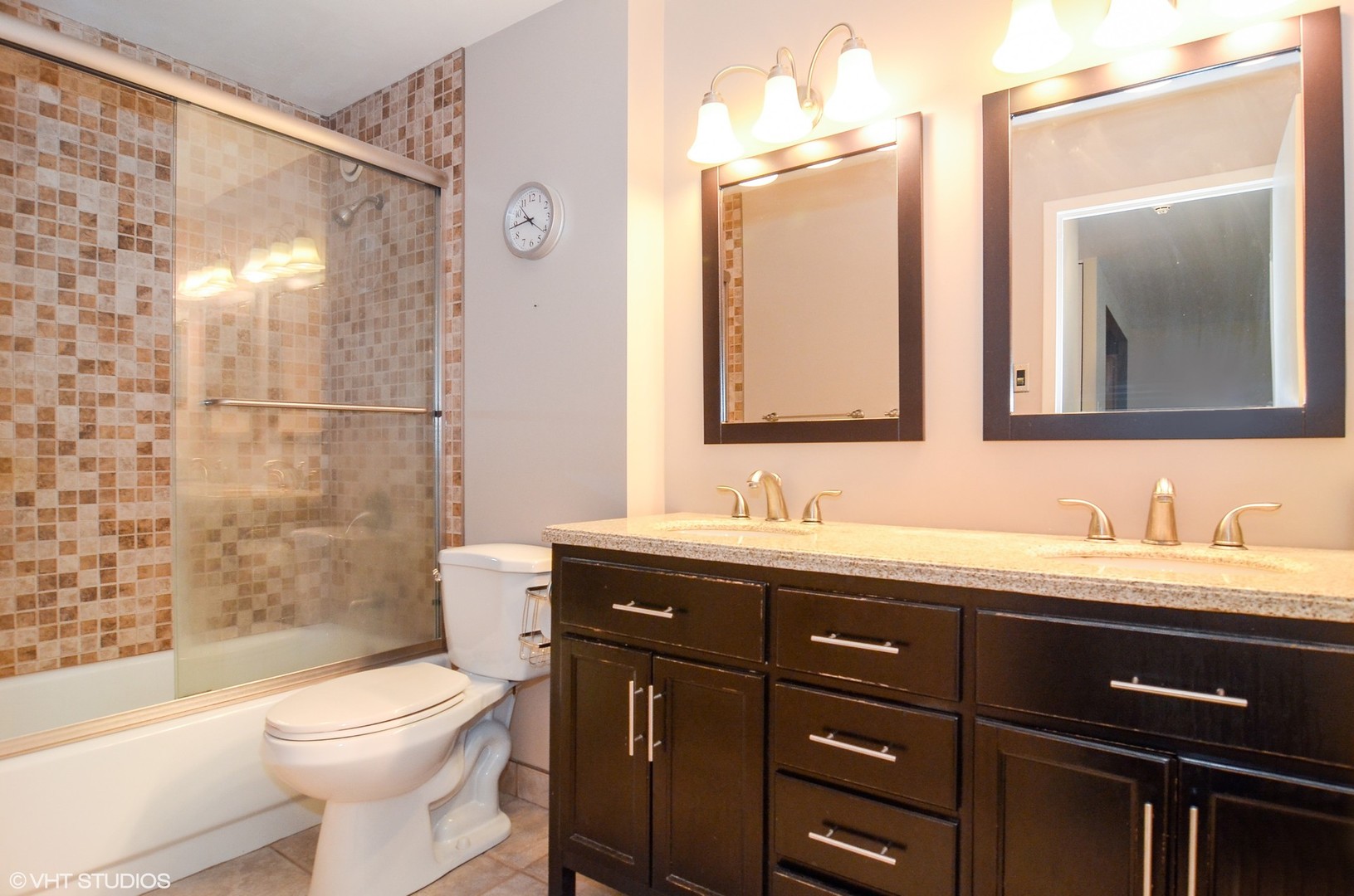 211 East Ohio Street, Unit 809 Chicago, IL 60611 - Photo 11 of 17 a bathroom with a double vanity sink toilet and shower