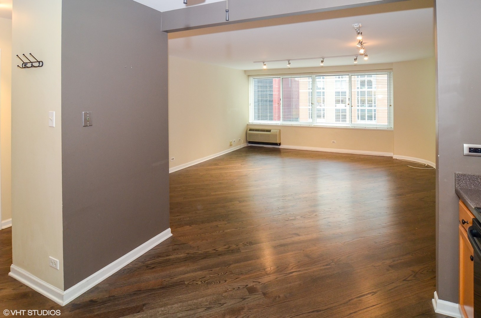 211 East Ohio Street, Unit 809 Chicago, IL 60611 - Photo 8 of 17 an empty room with wooden floor and windows