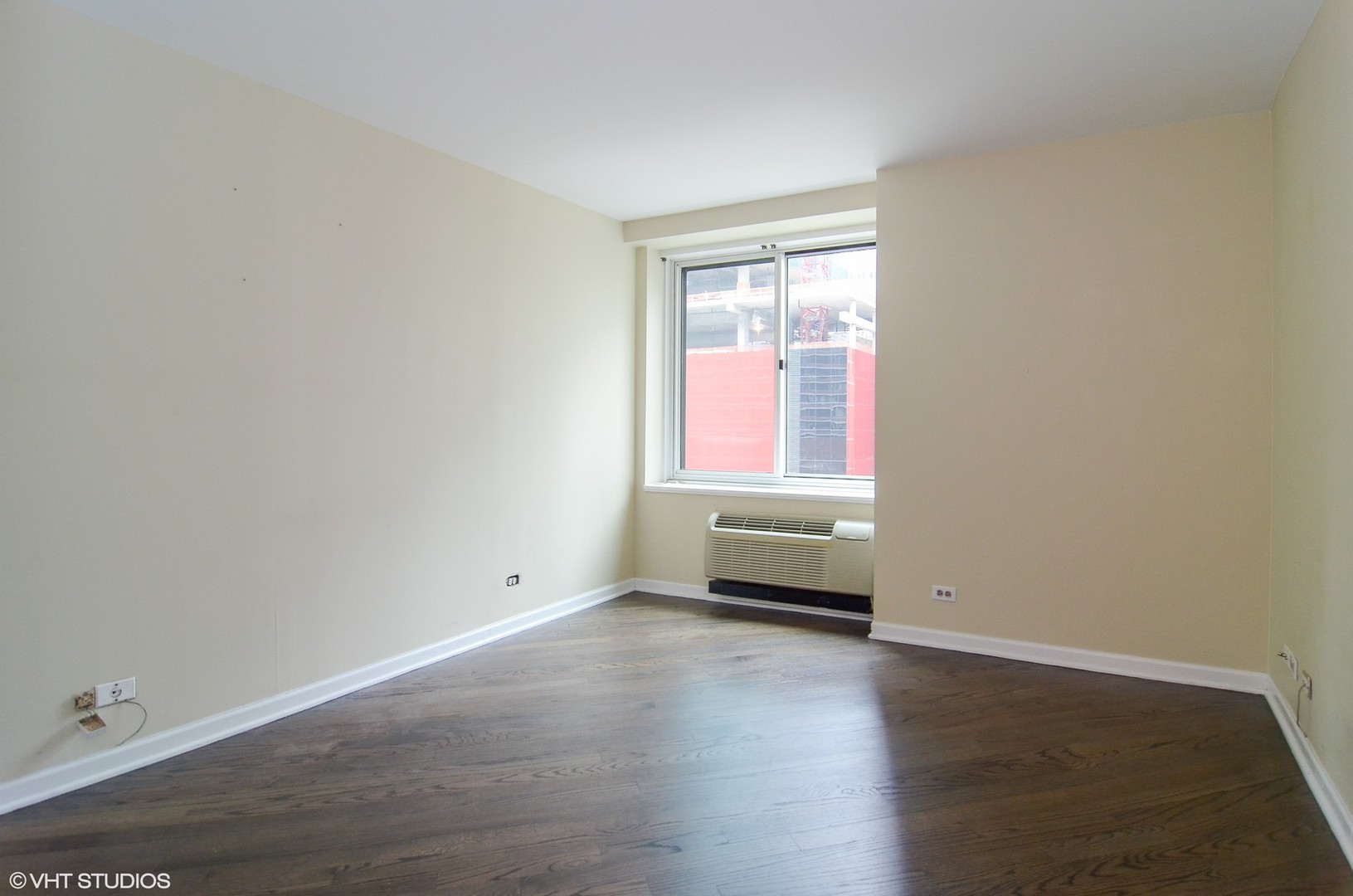 211 East Ohio Street, Unit 809 Chicago, IL 60611 - Photo 9 of 17 an empty room with wooden floor and windows