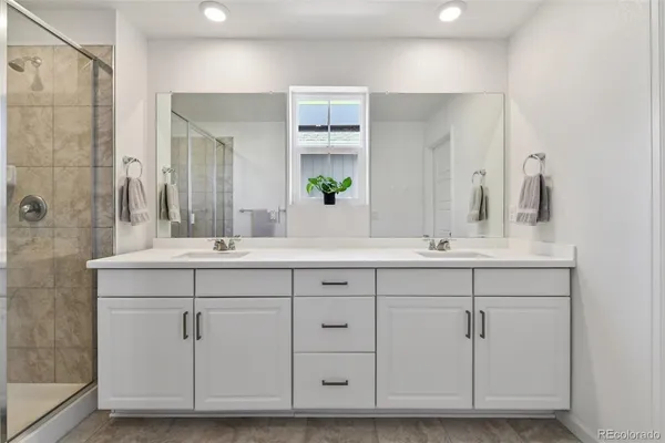 a bathroom with a double vanity sink mirror and