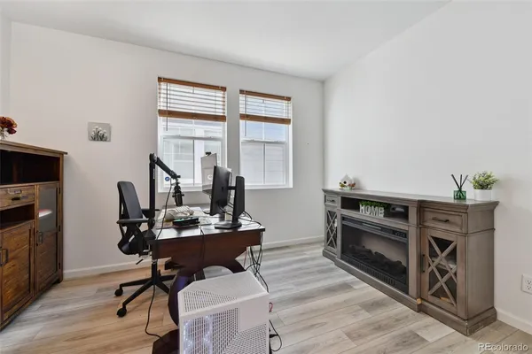 a view of a workspace with furniture and a window