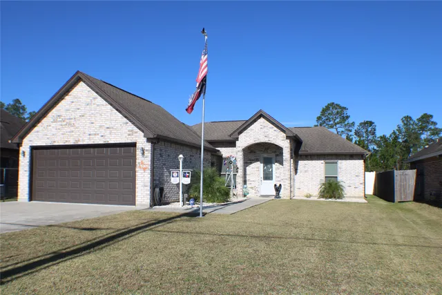 a view of a house with a yard and garage