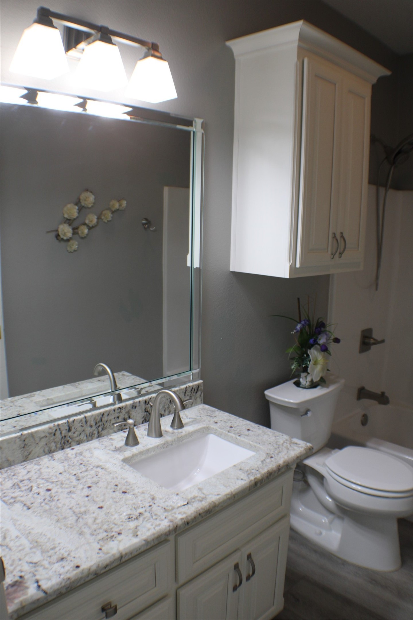 5305 Wheeler Road Lumberton, TX 77657 - Photo 34 of 48 a bathroom with a granite countertop sink a toilet and mirror