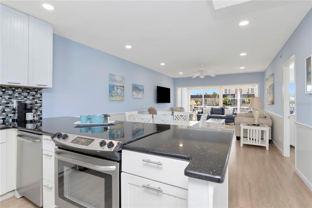 4390 Exeter Drive, Unit 305 Longboat Key, FL 34228 - Photo 16 of 78 a living room with furniture and a flat screen tv