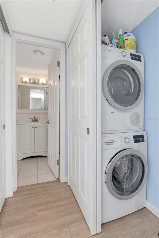 4390 Exeter Drive, Unit 305 Longboat Key, FL 34228 - Photo 17 of 78 a view of a hallway with washer and dryer