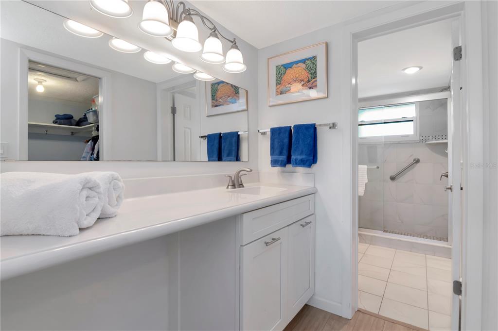 4390 Exeter Drive, Unit 305 Longboat Key, FL 34228 - Photo 24 of 78 a bathroom with a sink and a mirror