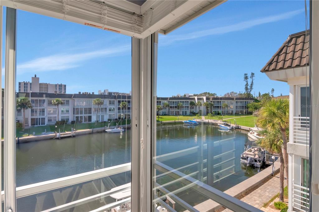 4390 Exeter Drive, Unit 305 Longboat Key, FL 34228 - Photo 27 of 78 a view of swimming pool from a balcony