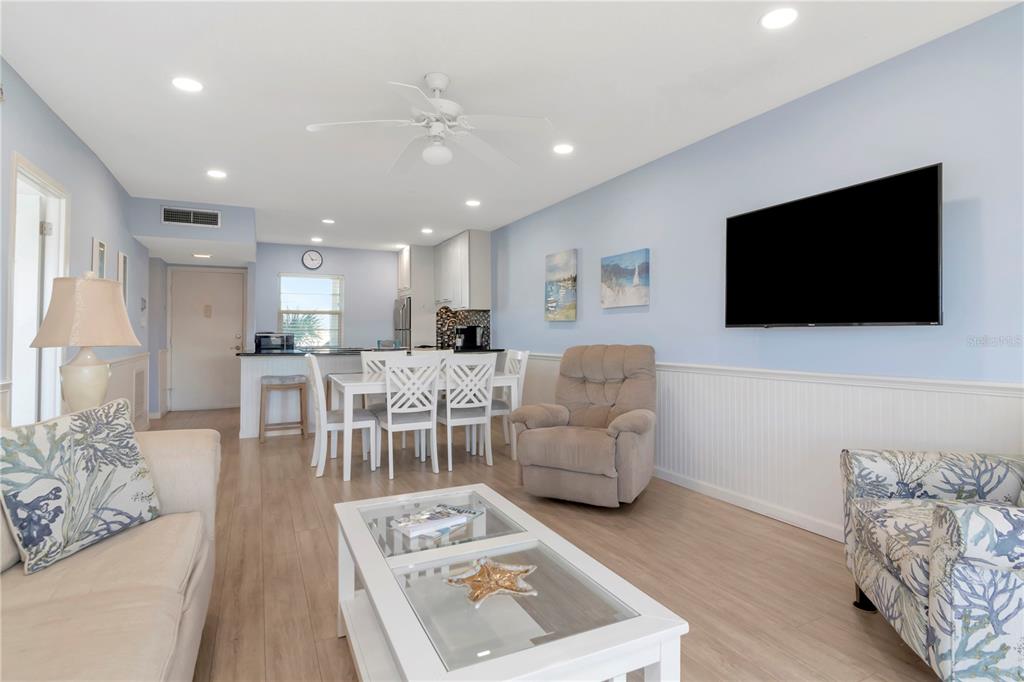 4390 Exeter Drive, Unit 305 Longboat Key, FL 34228 - Photo 3 of 78 a living room with furniture and a flat screen tv