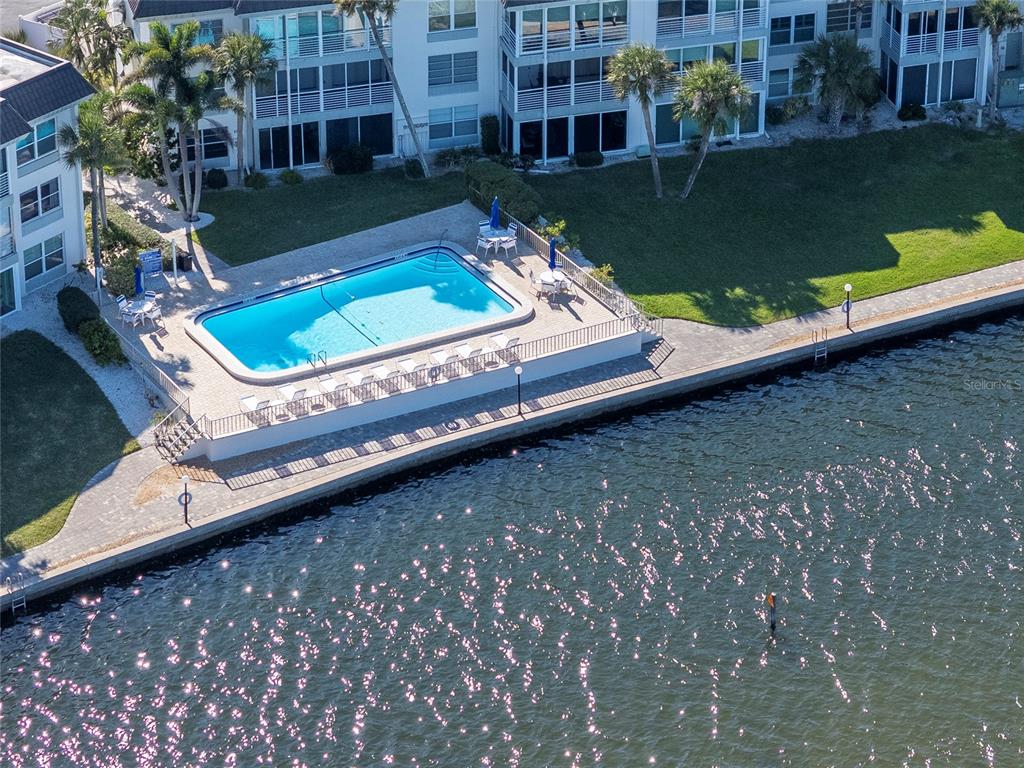 4390 Exeter Drive, Unit 305 Longboat Key, FL 34228 - Photo 34 of 78 a view of a swimming pool with a yard