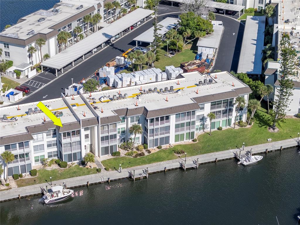 4390 Exeter Drive, Unit 305 Longboat Key, FL 34228 - Photo 46 of 78 a view of building with garden space and car parked