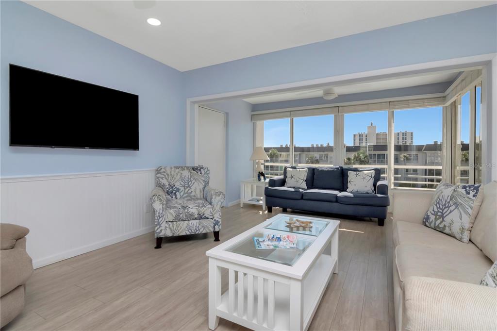 4390 Exeter Drive, Unit 305 Longboat Key, FL 34228 - Photo 7 of 78 a living room with furniture and a flat screen tv