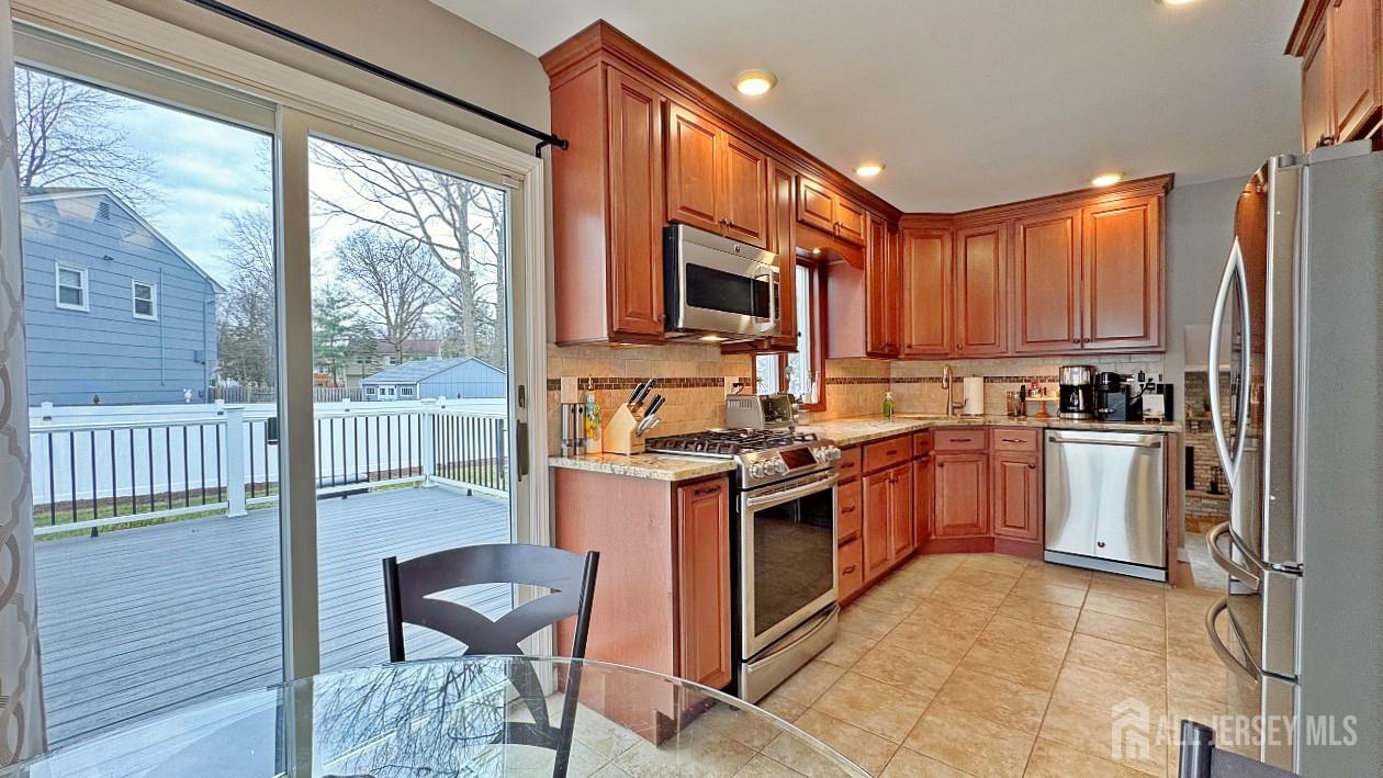 19 Norton Street Edison, NJ 08820 - Photo 11 of 29 a kitchen with granite countertop a stove top oven and cabinets