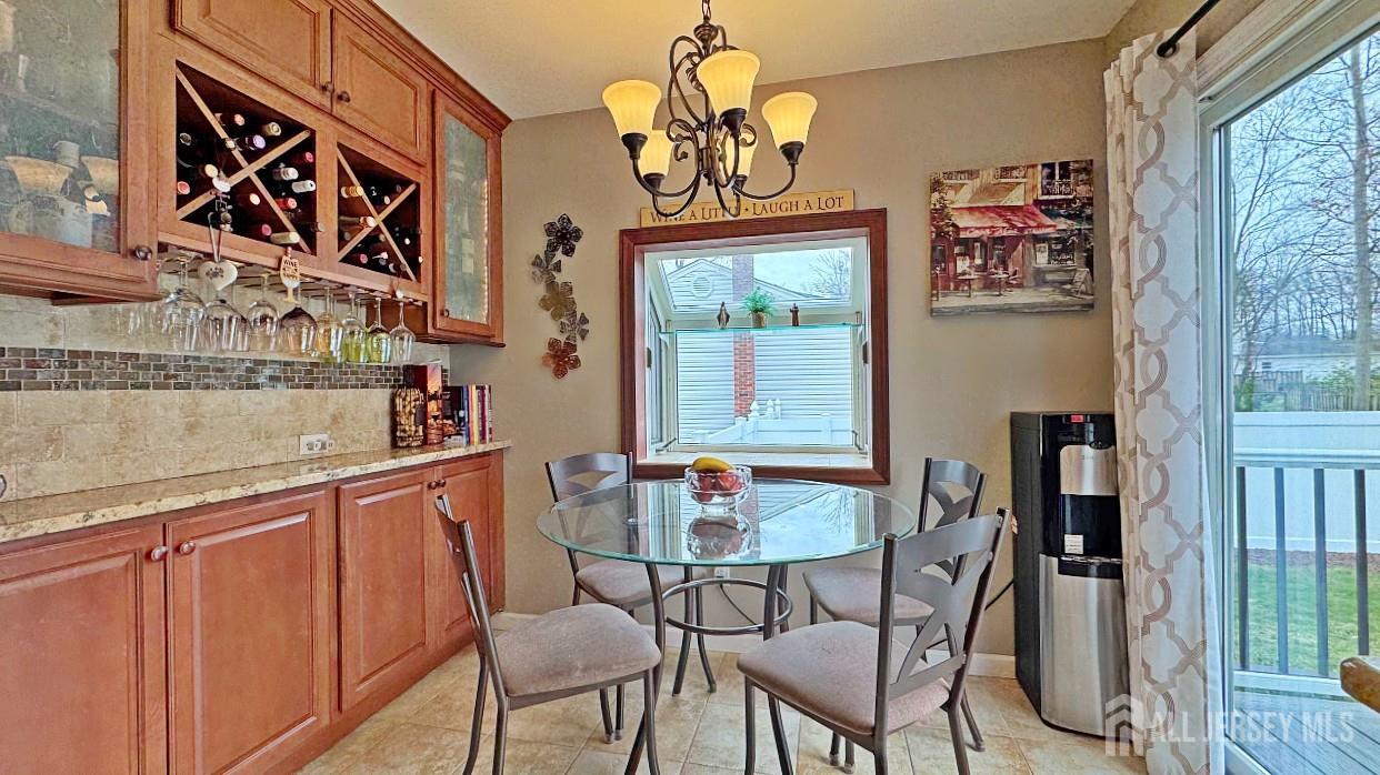 19 Norton Street Edison, NJ 08820 - Photo 12 of 29 a dining room with wooden floor and a chandelier