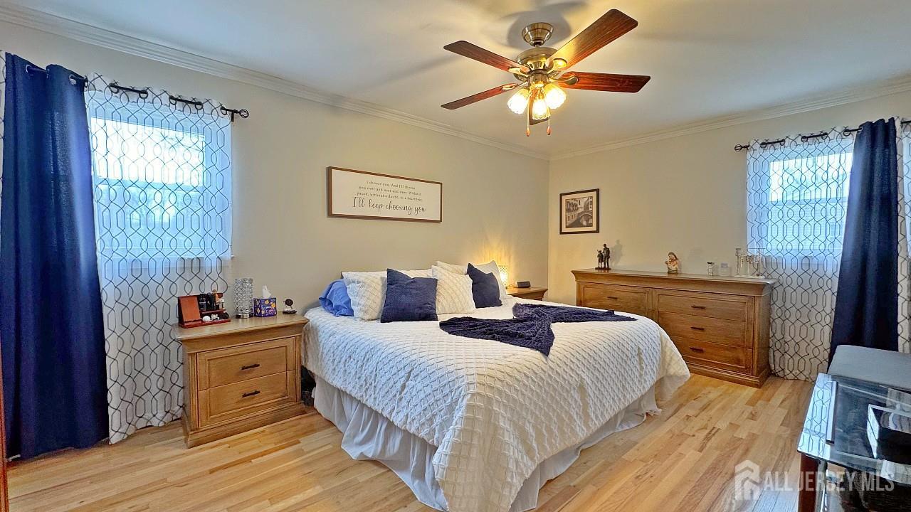 19 Norton Street Edison, NJ 08820 - Photo 17 of 29 a bedroom with a bed and a chandelier