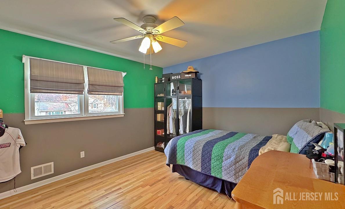 19 Norton Street Edison, NJ 08820 - Photo 20 of 29 a bedroom with a bed and a chandelier