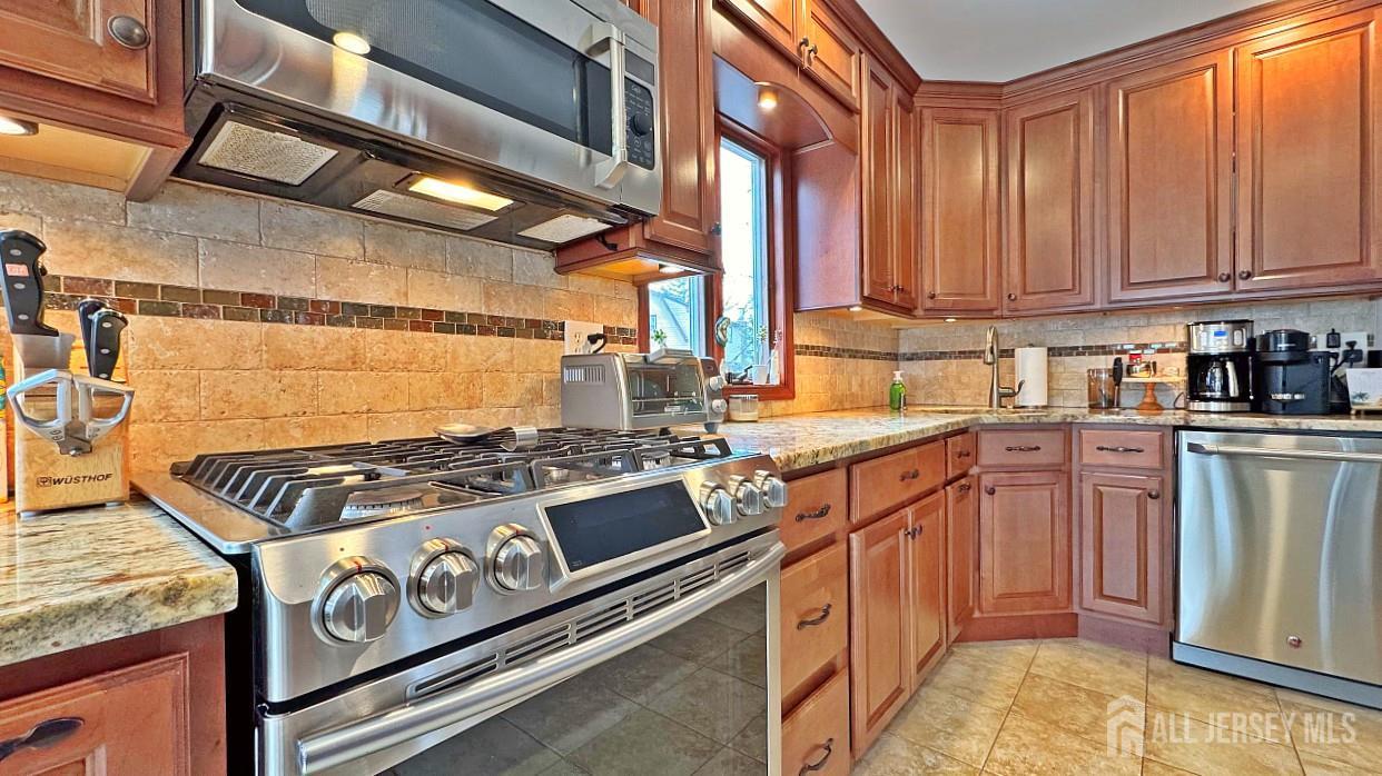 19 Norton Street Edison, NJ 08820 - Photo 9 of 29 a kitchen with stainless steel appliances granite countertop a stove and a sink