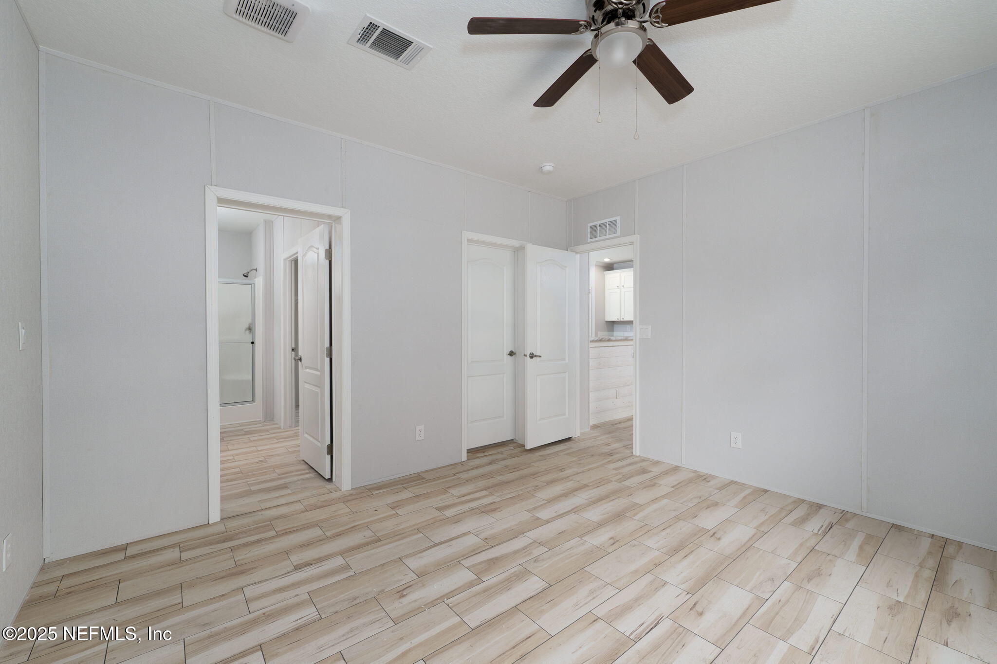 407 Sycamore Drive Macclenny, FL 32063 - Photo 11 of 25 a view of empty room with wooden floor and ceiling fan