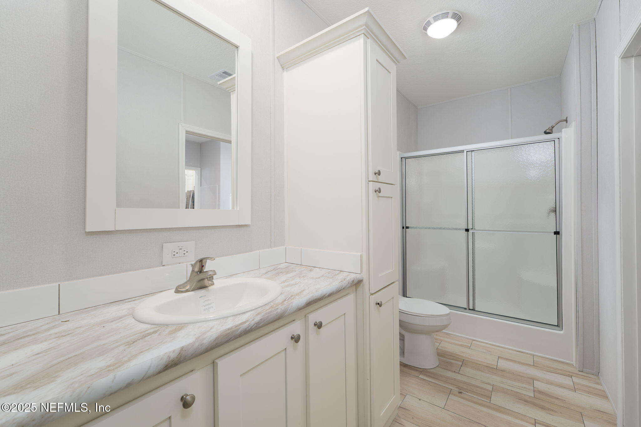 407 Sycamore Drive Macclenny, FL 32063 - Photo 12 of 25 a bathroom with a granite countertop sink toilet and shower