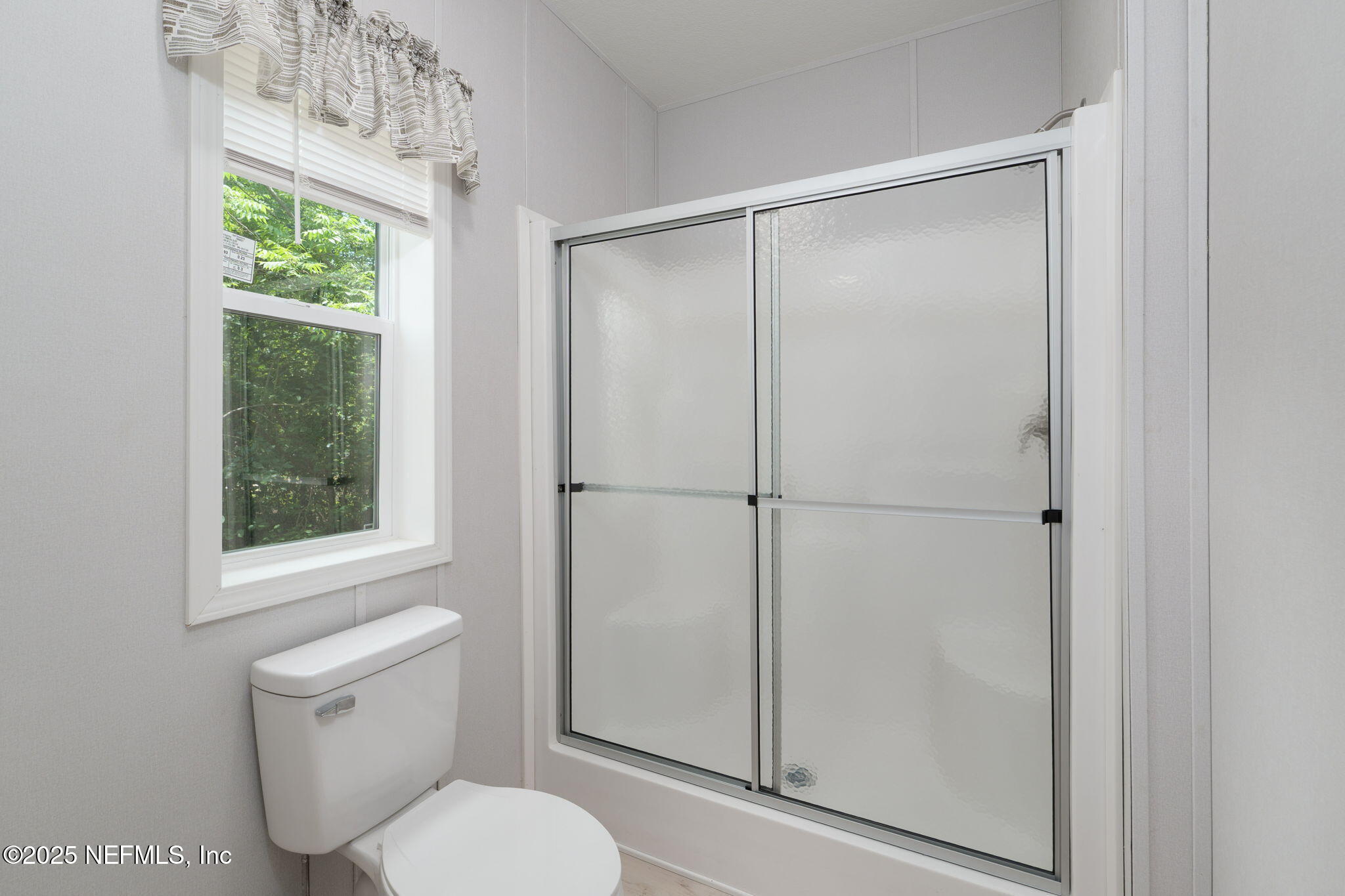 407 Sycamore Drive Macclenny, FL 32063 - Photo 13 of 25 a white toilet sitting next to a bathroom sink