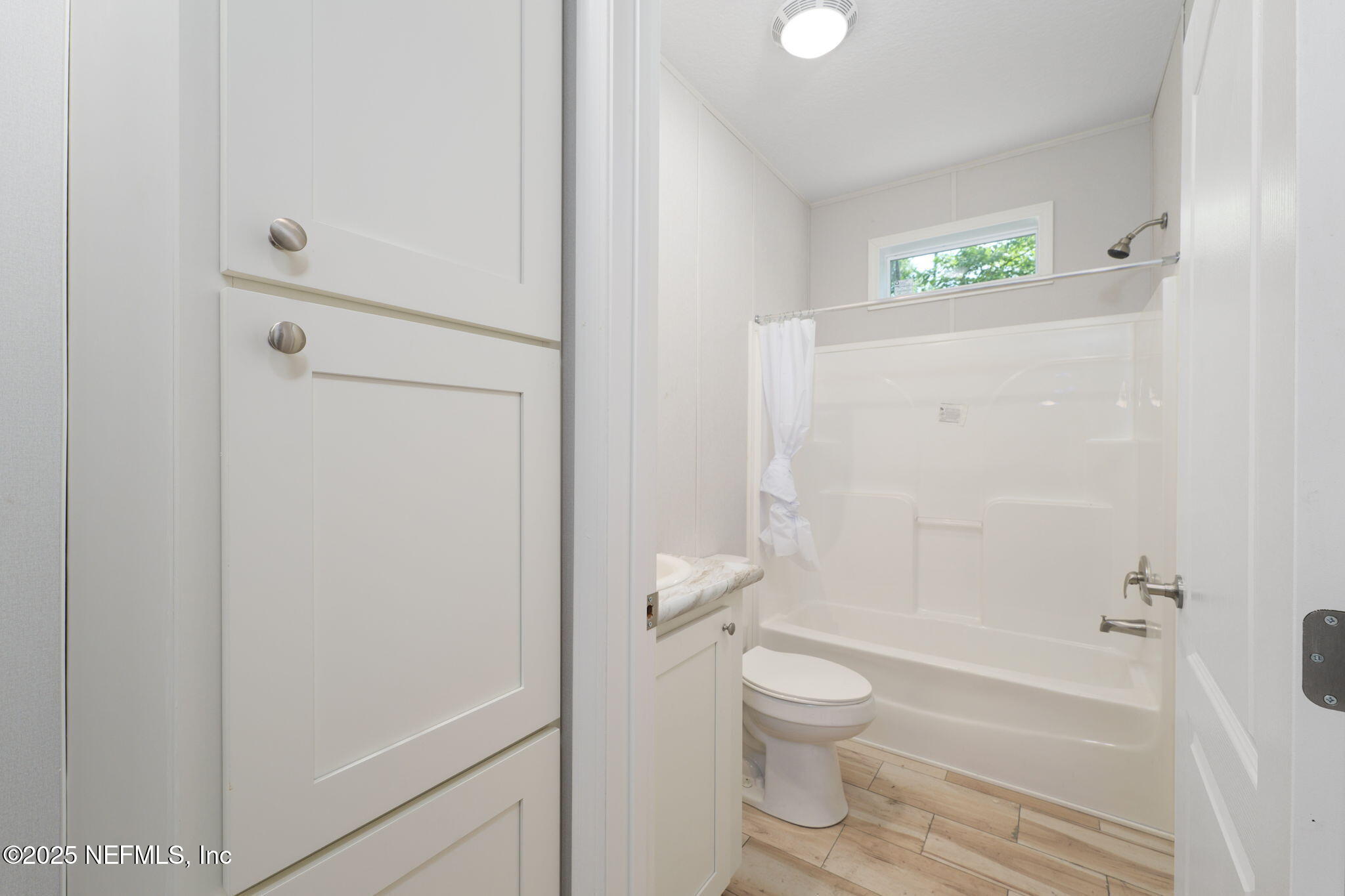 407 Sycamore Drive Macclenny, FL 32063 - Photo 14 of 25 a bathroom with a toilet and a shower