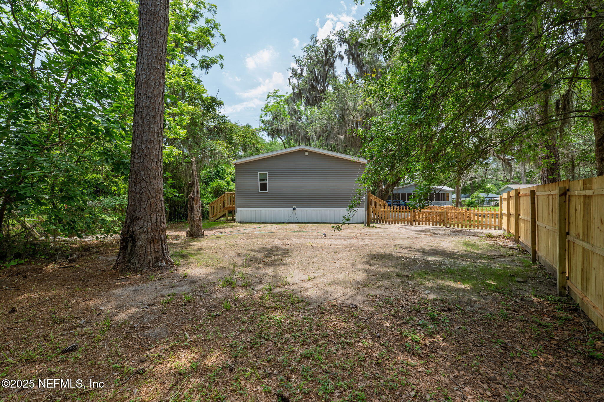 407 Sycamore Drive Macclenny, FL 32063 - Photo 23 of 25 a backyard of a house with large trees and plants