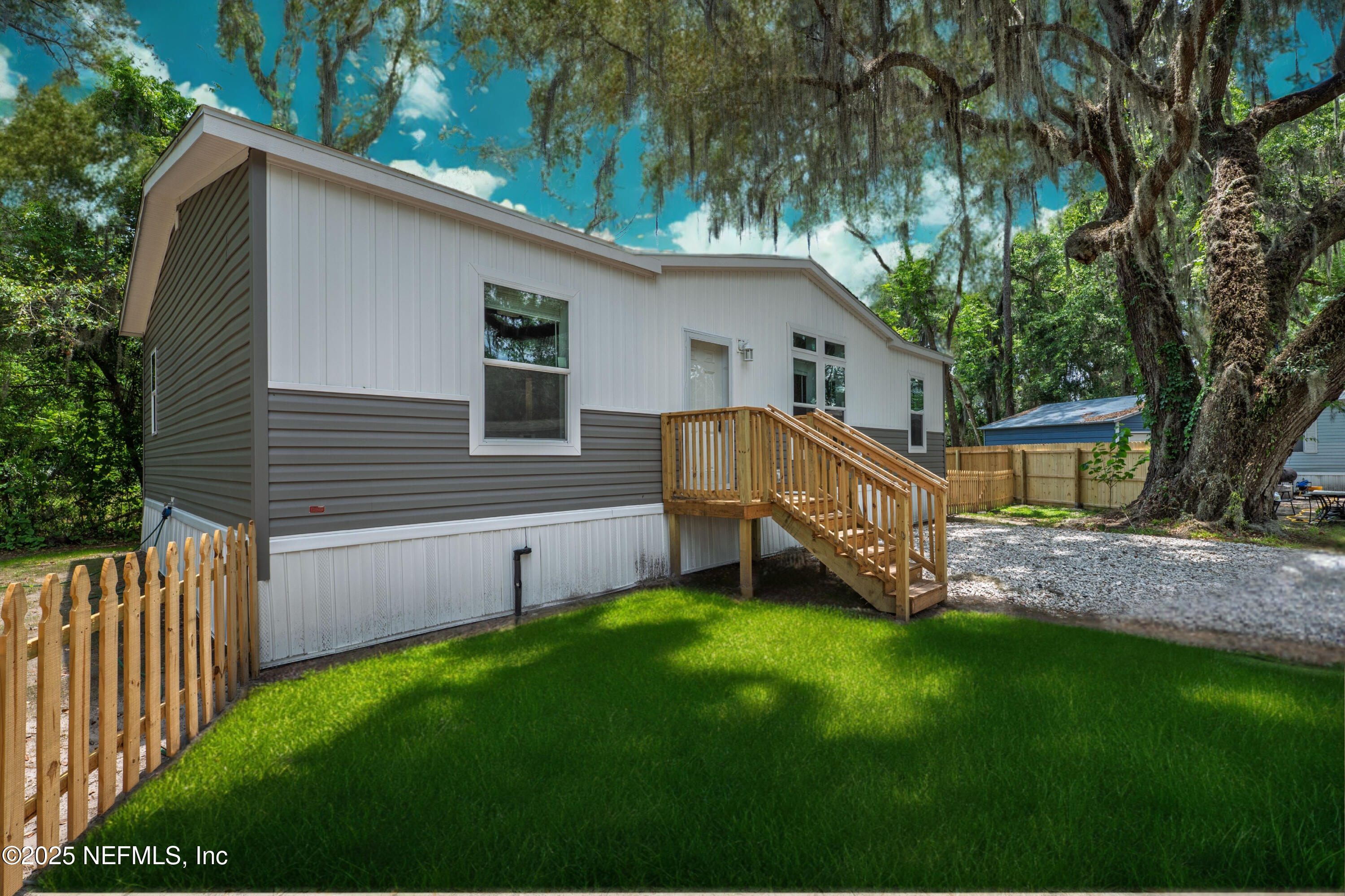 407 Sycamore Drive Macclenny, FL 32063 - Photo 25 of 25 a view of a house with a yard and a wooden deck