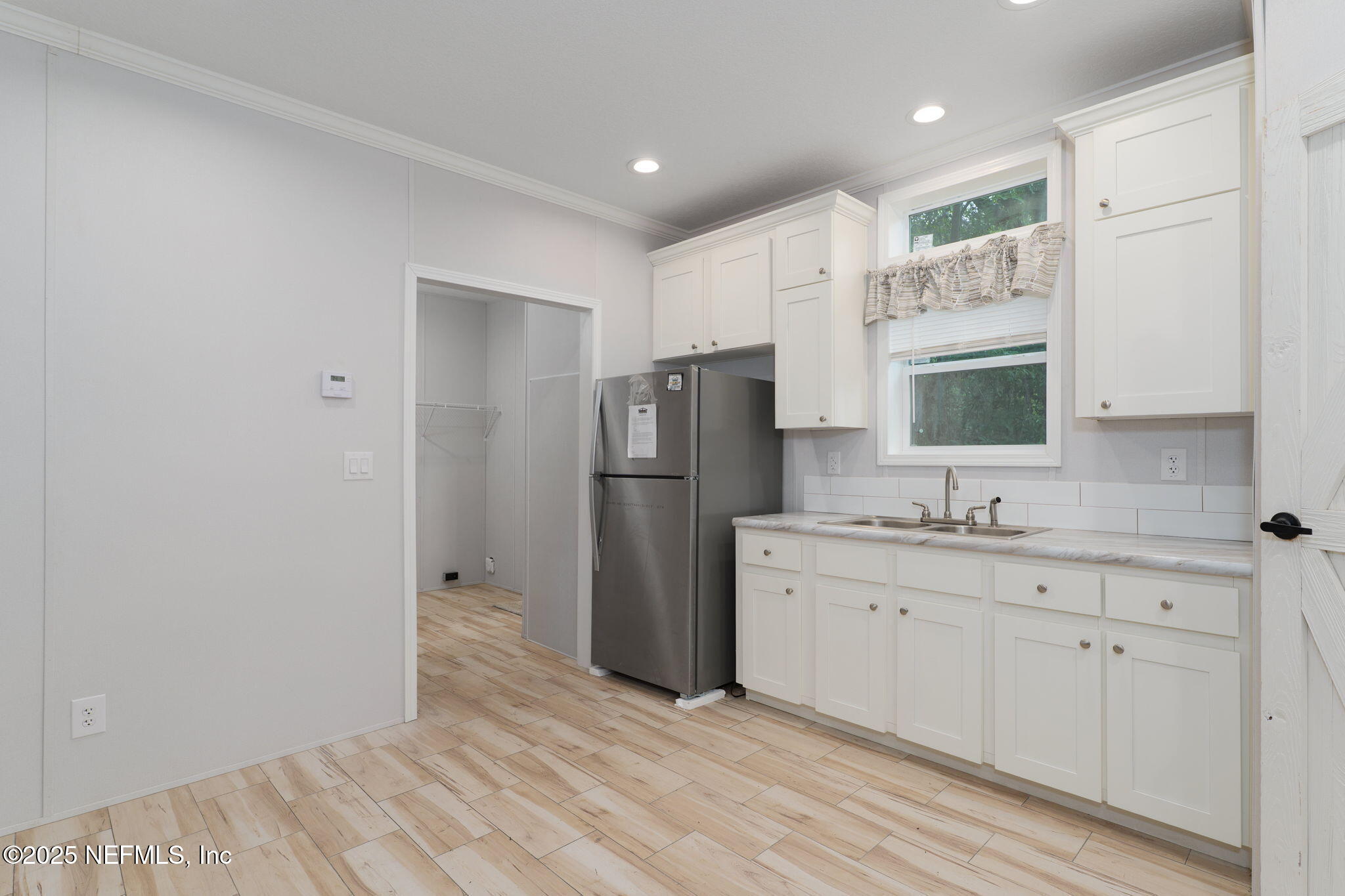 407 Sycamore Drive Macclenny, FL 32063 - Photo 5 of 25 a kitchen with stainless steel appliances a refrigerator sink and microwave