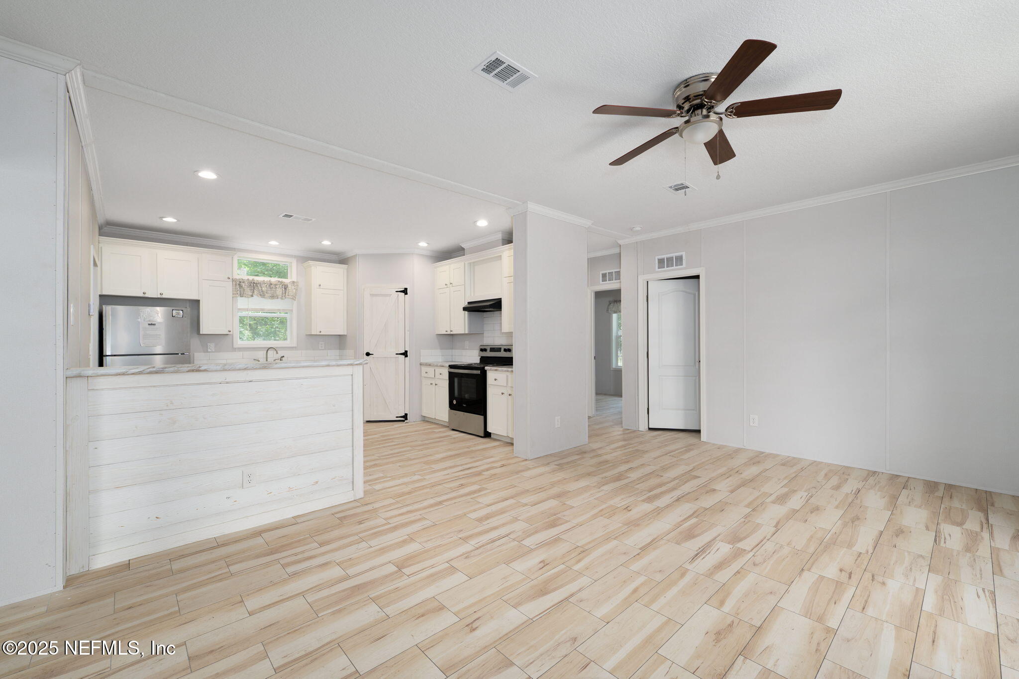 407 Sycamore Drive Macclenny, FL 32063 - Photo 6 of 25 a view of an empty room with kitchen and window