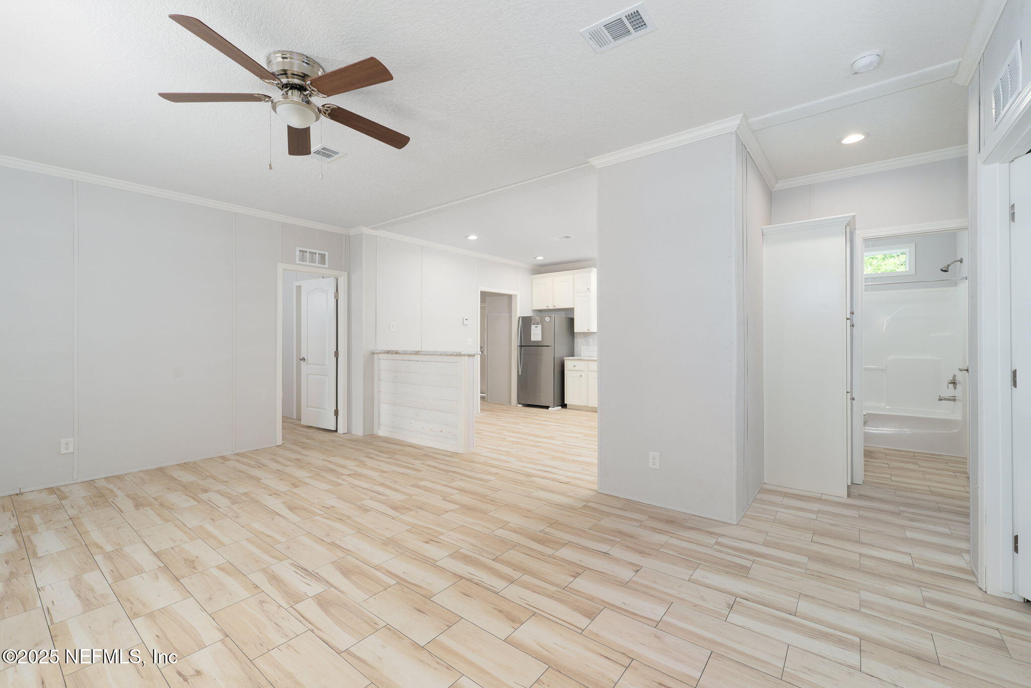 407 Sycamore Drive Macclenny, FL 32063 - Photo 8 of 25 a view of empty room with wooden floor and ceiling fan