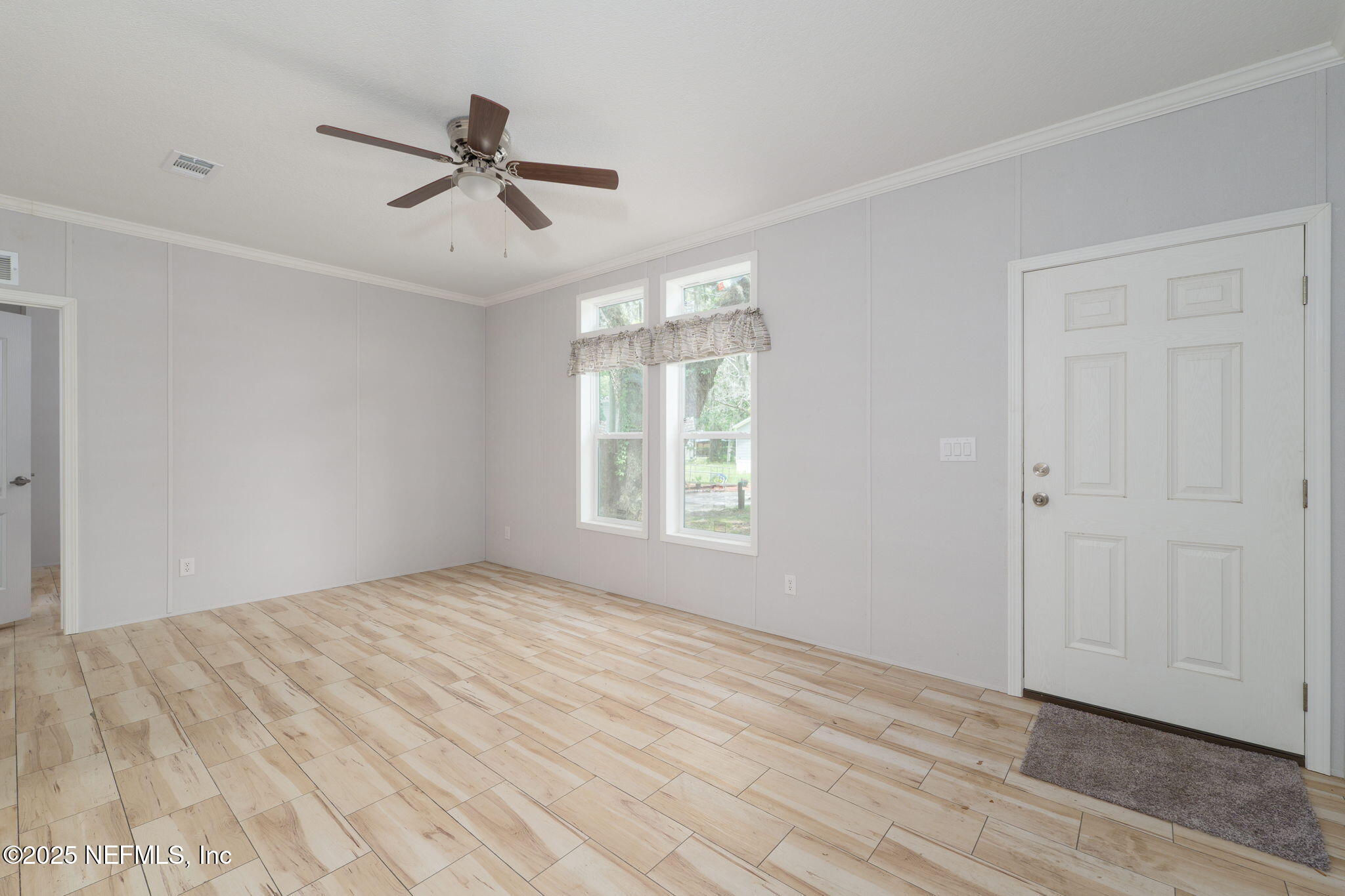 407 Sycamore Drive Macclenny, FL 32063 - Photo 9 of 25 a view of empty room with wooden floor and fan