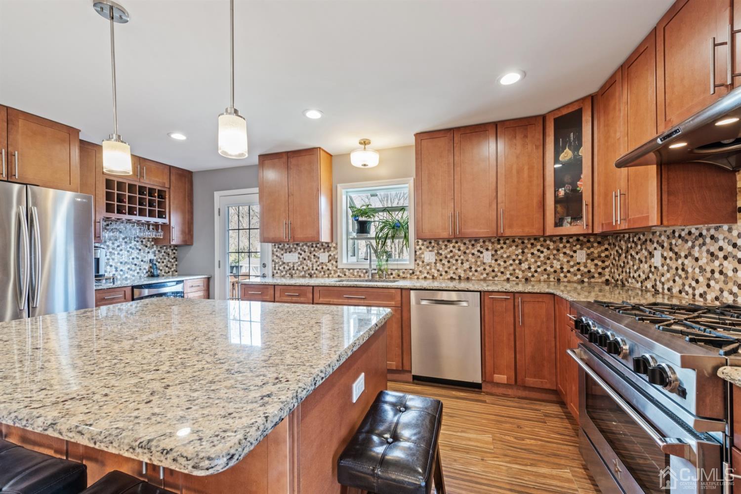1 Jefferson Road East Brunswick, NJ 08816 - Photo 13 of 29 a kitchen with stainless steel appliances granite countertop a sink a stove and a wooden floors