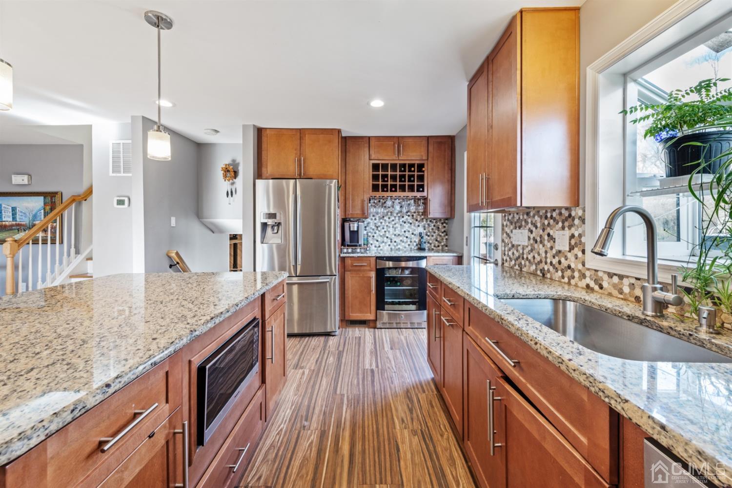 1 Jefferson Road East Brunswick, NJ 08816 - Photo 14 of 29 a kitchen with stainless steel appliances granite countertop a sink a stove and a wooden floors