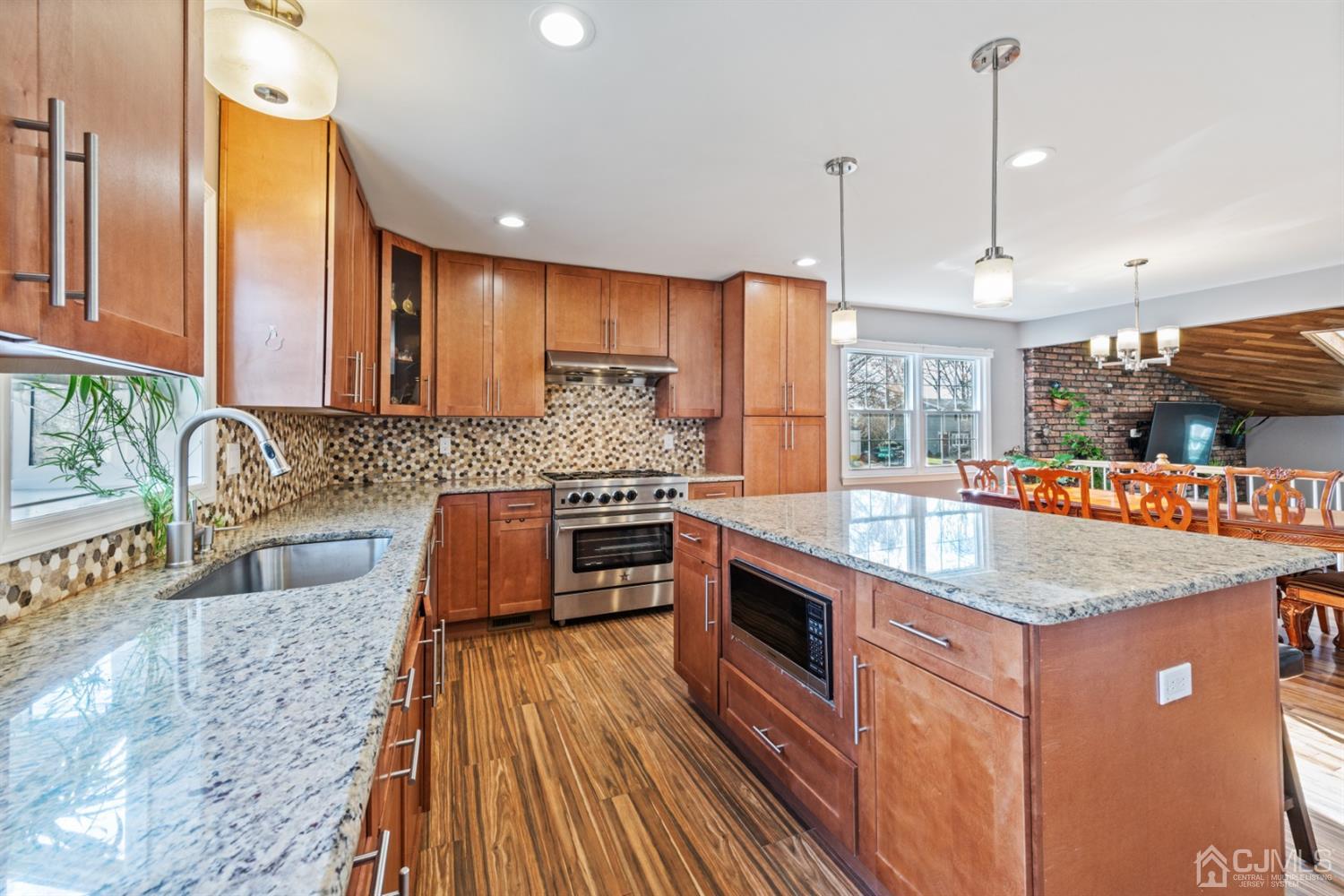 1 Jefferson Road East Brunswick, NJ 08816 - Photo 15 of 29 a kitchen with stainless steel appliances granite countertop a sink a stove top oven a counter space and cabinets