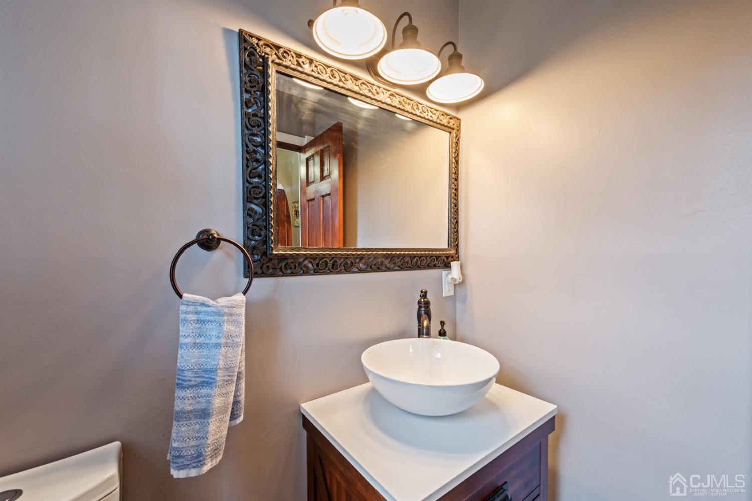 1 Jefferson Road East Brunswick, NJ 08816 - Photo 21 of 29 a bathroom with a sink and a mirror