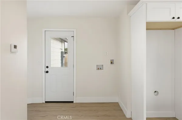 a view of a hallway with wooden floor
