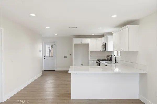 a kitchen with a sink stainless steel appliances and cabinets