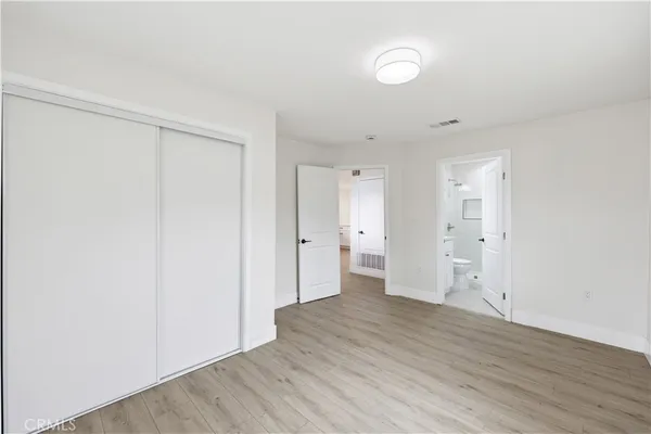 a view of a room with wooden floor and white doors